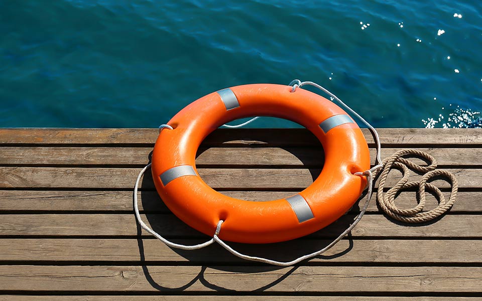 Lifebuoy ring on sea pier with space for text